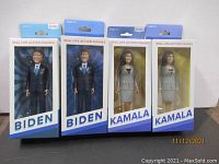 Front view of four boxed political action figures: two Joe Biden and two Kamala Harris figures, in original packaging.