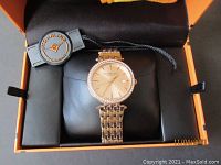 Stuhrling Women's Symphony gold tone watch displayed in original box with brand tag.