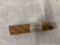 Photo of the 1941 wheat penny roll wrapped in a paper wrapper labeled for 50 pennies, with center marking '1941'.