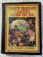 Front cover of the 1946 edition showing the title and underwater illustration with signs of wear and discoloration.