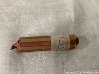 Paper roll wrapped tightly and labeled '1955', containing 50 unsearched 1955 wheat pennies.