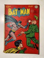 Front cover showing Batman punching a Nazi agent, title block 'BATMAN No.28 April-May Ten Cents' with war bond emblem