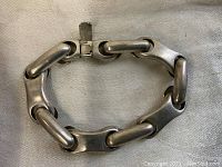 Chunky vintage sterling silver chain bracelet laid flat showing interlocking thick links and clasp.