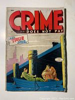 Front cover of the comic showing title Crime Does Not Pay No.39 with two men at a dock, one man seated in a boat and another carrying a box, color illustration with visible wear and tear on binding.