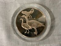 Front side of the Franklin Mint Roberts Bird Medal featuring three Nene (Hawaiian Goose) in proof finish.