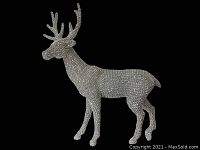 Close-up photo of the rhinestone-covered reindeer against black background to highlight detail and clarity of the piece.