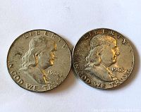 Obverse view showing Benjamin Franklin with dates 1962 and 1963 on two coins.