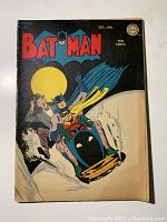 Front cover showing Batman and Robin riding in a snowy chase scene under a full moon