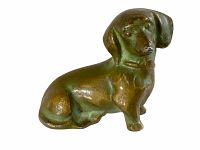 Front-side view of the small bronze dachshund figurine showing detailed facial features and body.