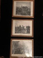 Photo of three framed black and white Napolean battle prints hung vertically.