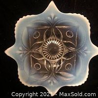 Top view of vintage square decorative plate showing light blue gradient color and embossed floral/geometric patterns with scalloped edges.