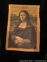 Photo showing the first vintage Mona Lisa wall tapestry with sepia tones and golden border detail