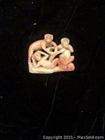 Front view of the monkey figurine showing the three monkeys in different poses with clear facial expressions and hand gestures.