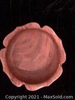 Top view of the round wooden salad bowl with scalloped edges showing natural wood grain and smooth interior surface.