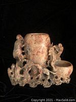 Front view of the marble vase showing the three monkeys climbing and playing, vase center, and small bowl attached.