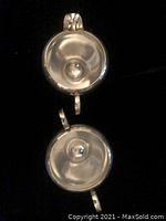 Top view showing interior of two small silver bowls with rounded bases and shallow interiors