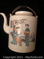 Front side image showing painted geisha women in traditional kimonos with floral elements and a bridge in the background.