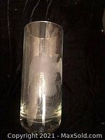 Full front view of the tall clear glass vase showing the etched eagle, crown, and phrase design.
