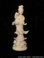 Front view of white porcelain Chinese woman figurine on floral base