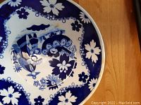 Close-up of the shallow blue and white bowl showing Eskimo Child central pattern and floral border in cobalt blue