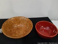 Both bowls side by side on a tabletop showing size and color contrast