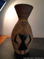 Front view of vase showing stylized woman in black dress