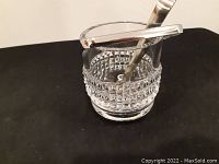 Clear view of the full lead crystal ice bucket showing the geometric cut diamond pattern and the accompanying tongs resting inside the bucket.