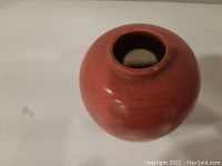 Photo showing top and side view of small round rose crackle glaze pottery vase.