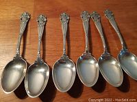 Six Towle Georgian pattern sterling silver teaspoons, showing detailed floral and scroll handles, bowls visible