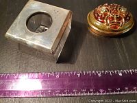 Hair receiver box and compact side by side with ruler for size reference