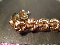 Close-up photo of the bracelet links showing the twisted rope design and clasp.