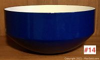 Front and side view of large blue enamelware bowl with white interior, showing full shape and color.