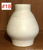 Front view of the white Moorcroft pottery vase showing shape and subtle rope detail near top.