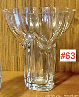 Front and side views of clear glass vase showing its unique wavy organic petal-shaped rim and solid base, with a tiny flea bite visible upon close inspection at the rim area.