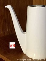 Side view of the porcelain coffee pot highlighting the angular spout