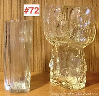 Front view of two clear textured glass vases, left taller and slimmer, right shorter and wider with irregular shape.