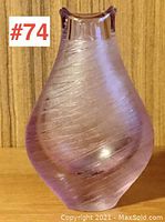 Side view of textured vase showing the swirled ribbed surface and color.