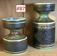 Photo showing both Mid-Century Modern Norwegian pottery candle holders side by side against wooden background.