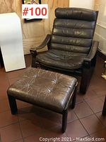 Front view of brown leather recliner and ottoman