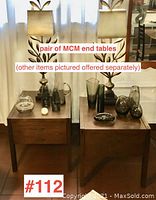 Pair of walnut end tables side by side with decorative objects