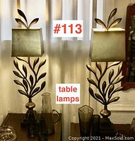 Full view of both lamps on tabletop against drapes