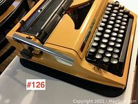 Angled view showing side lever, carriage return, keyboard and body