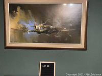 Framed print showing Spitfire aircraft flying through clouds with smoke trails, signature of artist visible.