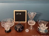 Full view of all seven crystal pieces arranged on surface showing variety and style