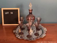 Full view of decanter set with tray and six aperitif glasses arranged around decanter