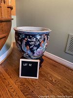 Full view of the planter on stand near staircase, showing overall height and bowl shape