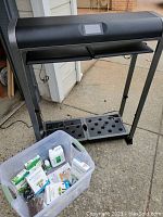 Full view of Hydroponic system frame with LED lamp overhead and clear tote of accessories at front