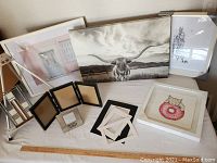 Photo showing the arrangement of various picture frames, mats, the limited edition giclee art print, and metal folding easel.