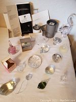 Overview of lot items including paperweights, figurines, and boxed Swarovski items.