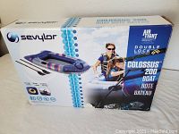 Box showing product image of the Sevylor Colossus 200 inflatable boat with air-tight double lock system.